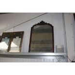 A mahogany and bevelled edge wall mirror