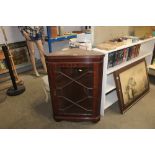 An glazed corner cabinet