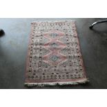 An approx. 4' 1" x 2' 8" pink pattern rug