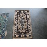 An approx. 3'8" x2'1" floral pattern rug