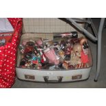 A suitcase of various souvenir dolls