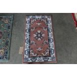 An approx. 4'8" x 2' floral pattern rug