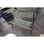 A wooden and metal two seater garden bench