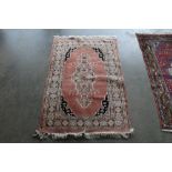An approx. 4'1" x 2'7" pink pattern rug