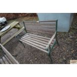 A wooden and metal two seater garden bench