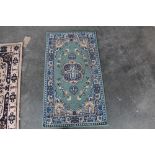 An approx. 3'8" x 2' floral pattern rug