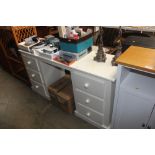 A modern white painted pedestal desk