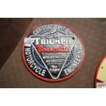 A painted cast iron sign for Triumph Motorcycles (