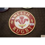 A circular painted cast iron sign for Welsh Rugby