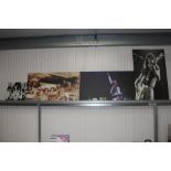 Four canvas prints of Led Zeppelin; Prince; Malcolm Young AC/DC and Liam Gallagher