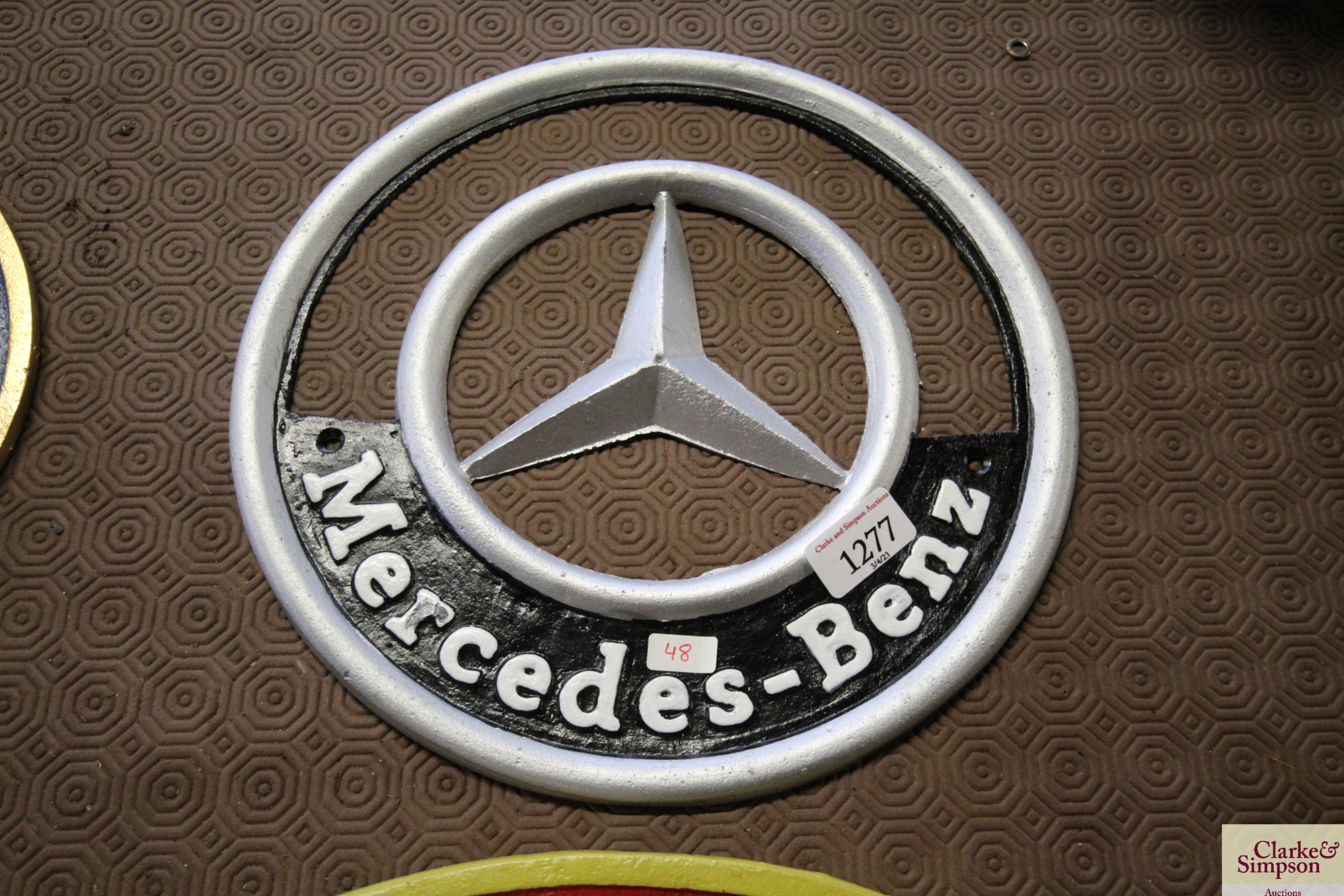 A painted cast iron sign for Mercedes-Benz (cm-48)