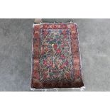 An approx. 2'5" x 1'8" floral Eastern pattern rug