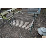 A wooden and metal two seater garden bench