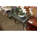 A pair of brass and glass topped side tables