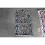 An approx. 3'8" x 2' floral pattern rug