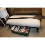 An upholstered long footstool