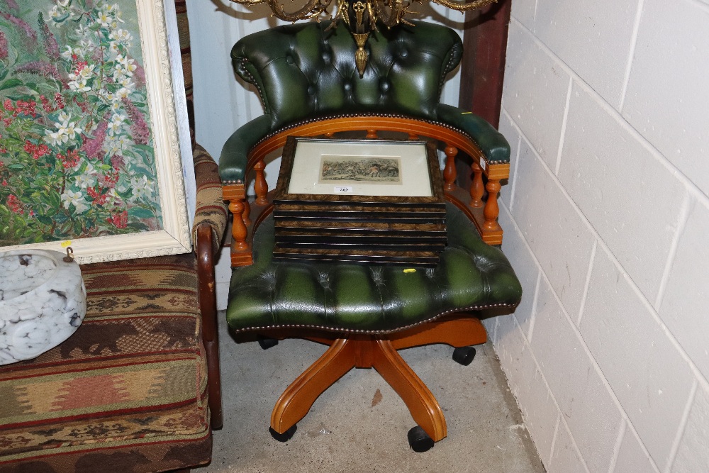 A green leather buttoned swivel office chair