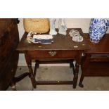 An antique oak side table fitted with a single dra