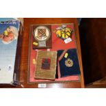 A collection of vintage badges and crests; and a c