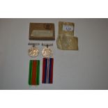 Two WWII medals with ribbons in box