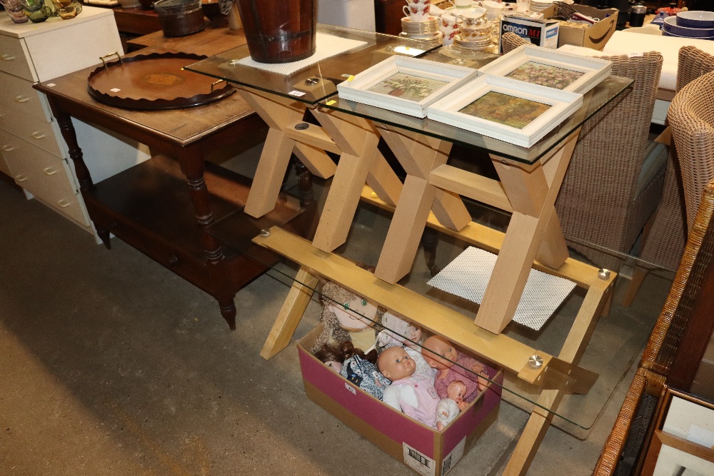 A wooden and glass coffee table on cross frame sup