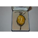 A large Art Deco style butterscotch amber pendant