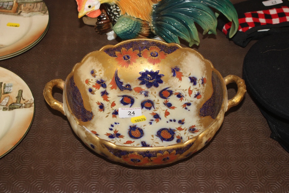 A Carlton ware floral and gilt decorated twin hand