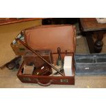 A vintage suitcase and contents to include a cast