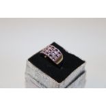 A boxed white metal and pink stone set ring