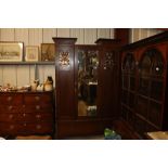 An Arts & Crafts wardrobe having copper panels and
