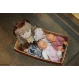 A box of various dolls