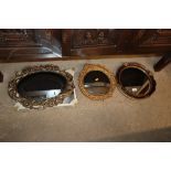 Three gilt framed decorative wall mirrors and a wr