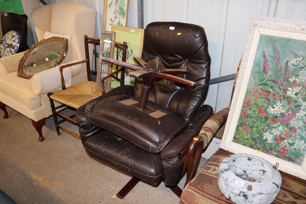 A retro leather upholstered swivel easy chair and