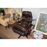 A retro leather upholstered swivel easy chair and