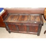 An antique carved oak coffer