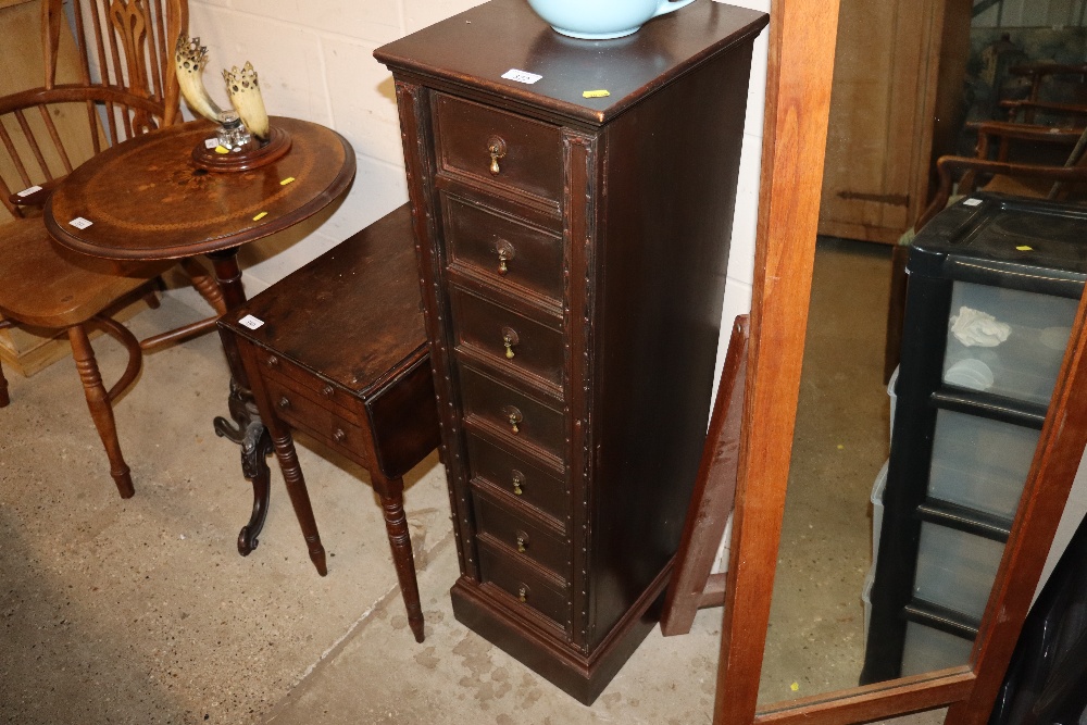 A Wellington type narrow chest of drawers