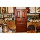 A dark pine storage cupboard fitted five drawers b