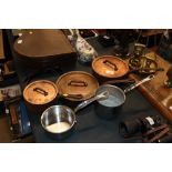 Three copper and iron saucepans and two others