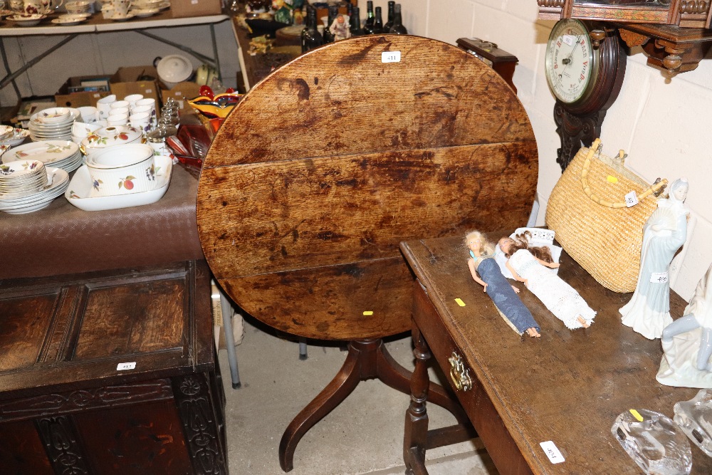 An antique elm tripod snap top occasional table