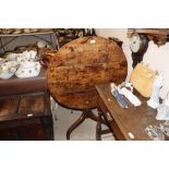 An antique elm tripod snap top occasional table