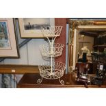 A cream painted wire work three tier work stand