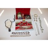 A cream coloured jewellery box and contents of var