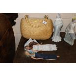 A wicker and bamboo evening bag and two Barbie dol