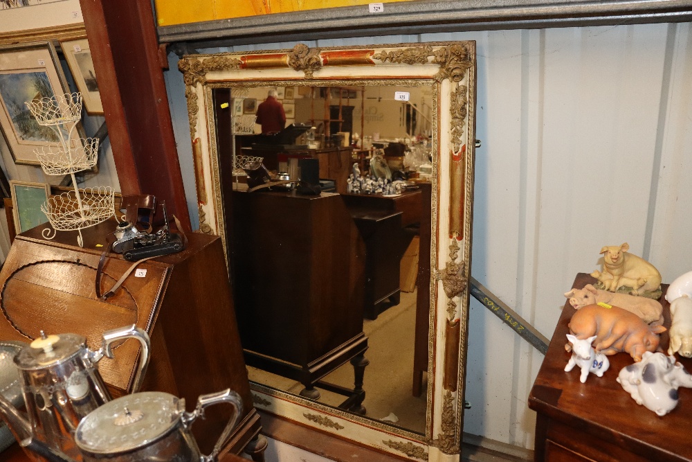 A large decorative cream and gilt wall mirror