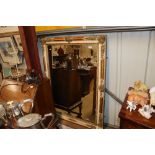 A large decorative cream and gilt wall mirror