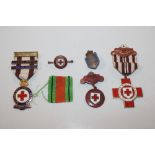 A collection of enamel decorated medals and badges