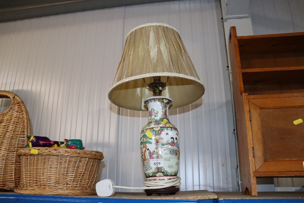 An Oriental vase converted to a table lamp