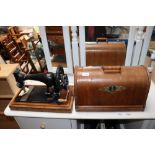 A Singer hand sewing machine with fitted case