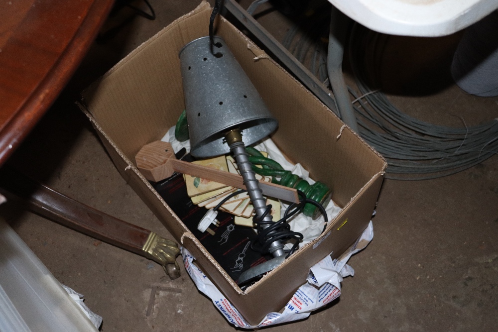 A box containing a table lamp, various coasters et