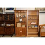 A pine open fronted bookcase on cupboard base